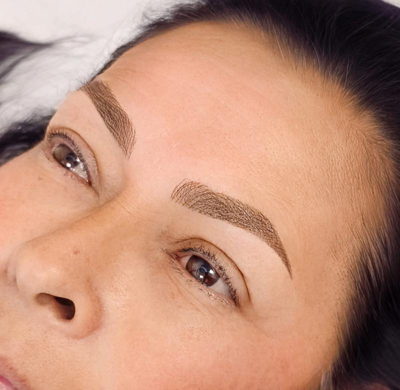 Microblading with fine hair strokes by Brenda Cazares in National City, mimicking natural eyebrow hair for a soft, realistic result.